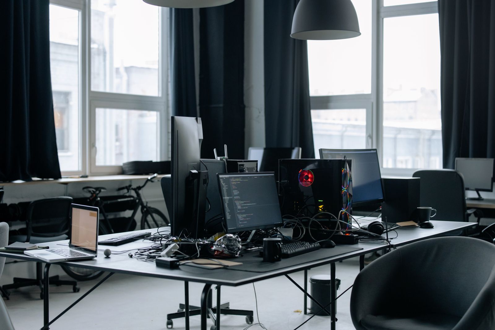 Workstations with computers and code on screen in a startup office
