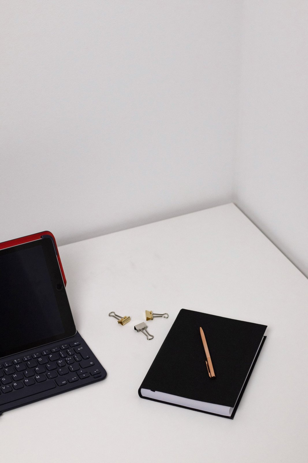 A notebook and keyboard arranged on a clean desk